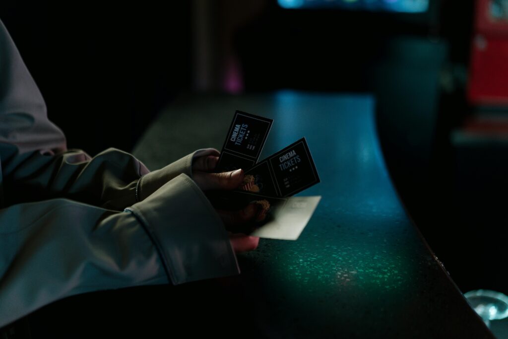 hand holding cinema tickets